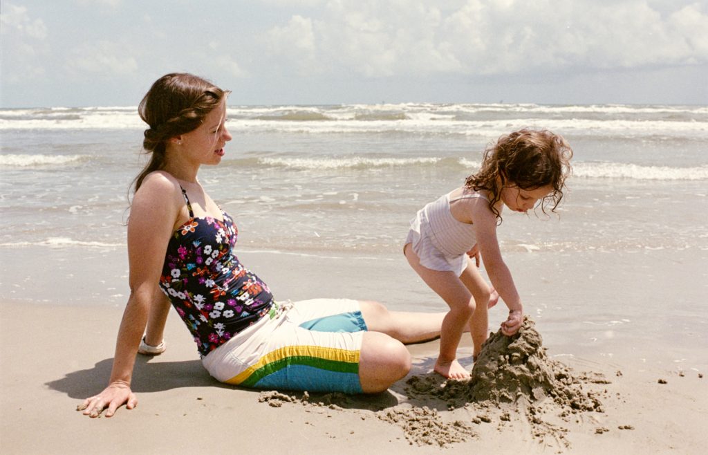 Mother and daughter on the beach, building a sandcastle. Photo taken on Fujifilm Superia on a Pentax P3 camera with the Pentax 43mm Limited Lens.